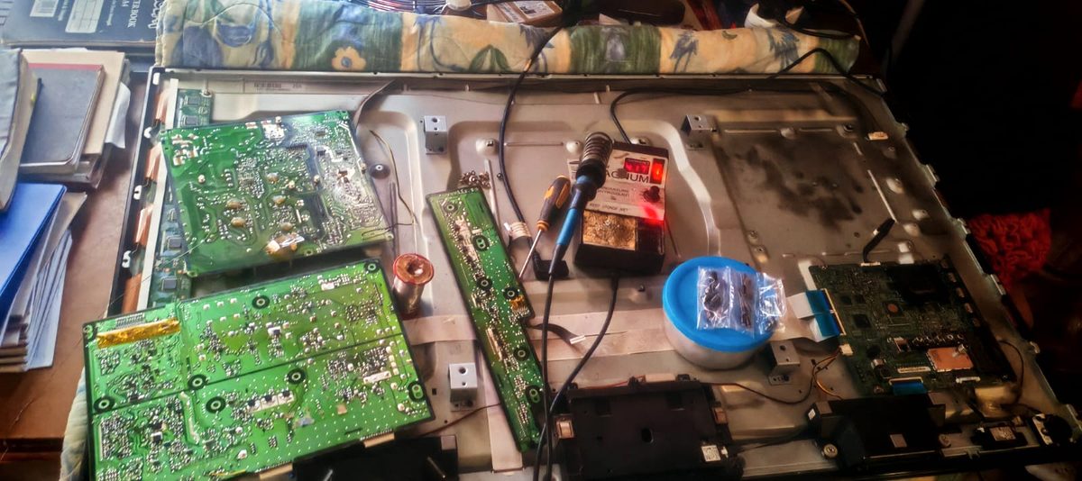 Television circuit boards laid out on a workbench after being removed for inspection