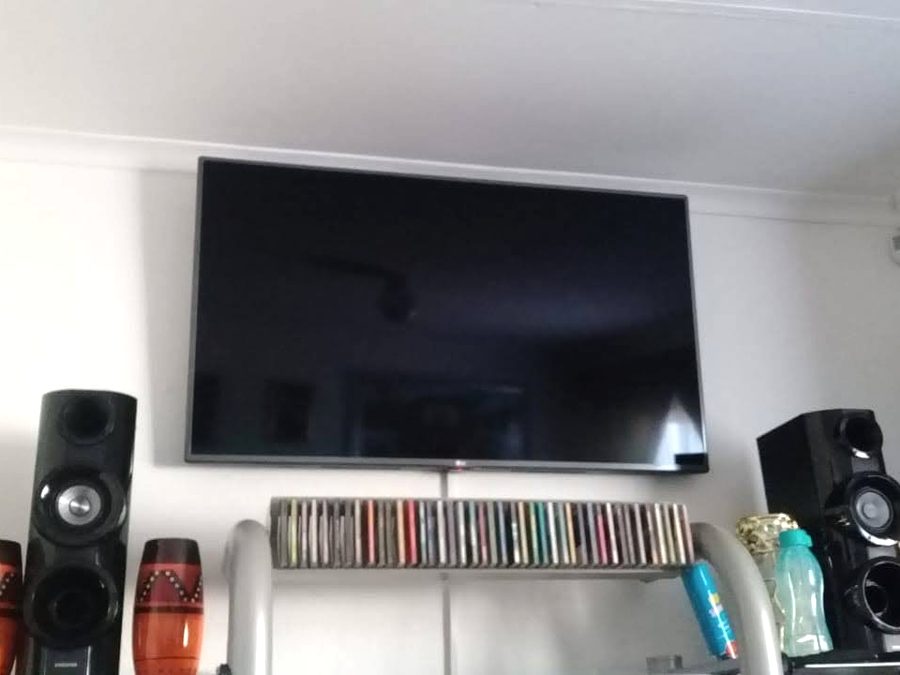 Wall-mounted television installed and working in a lounge